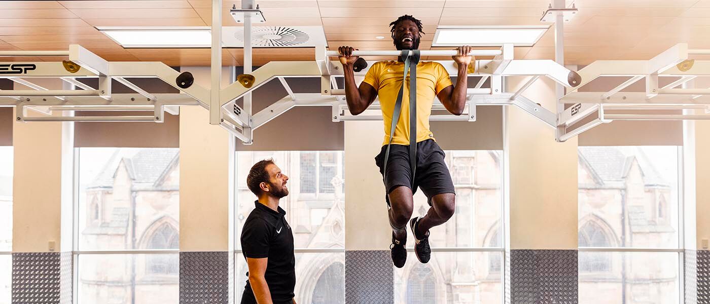 Jeff doing pull-ups in PowerPlay with training coach